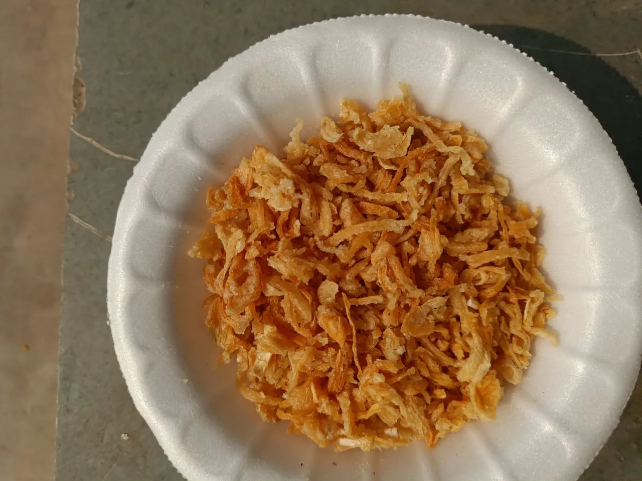 Crisp golden fried onion in a bowl