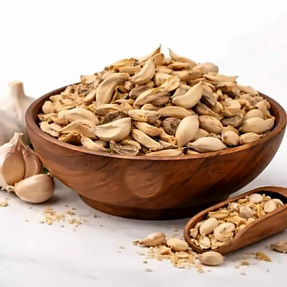 Dehydrated Garlic Flakes (Unsorted) in a wooden bowl