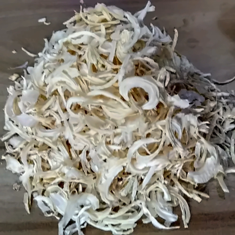 Dehydrated White Onion Flakes in a wooden bowl